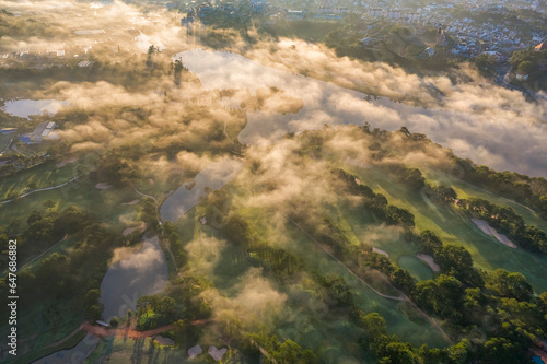 Top view aerial photo from flying drone of a Da Lat City with development buildings and fog nature beautifull  famoust travel city of Vietnam. Doi Cu area