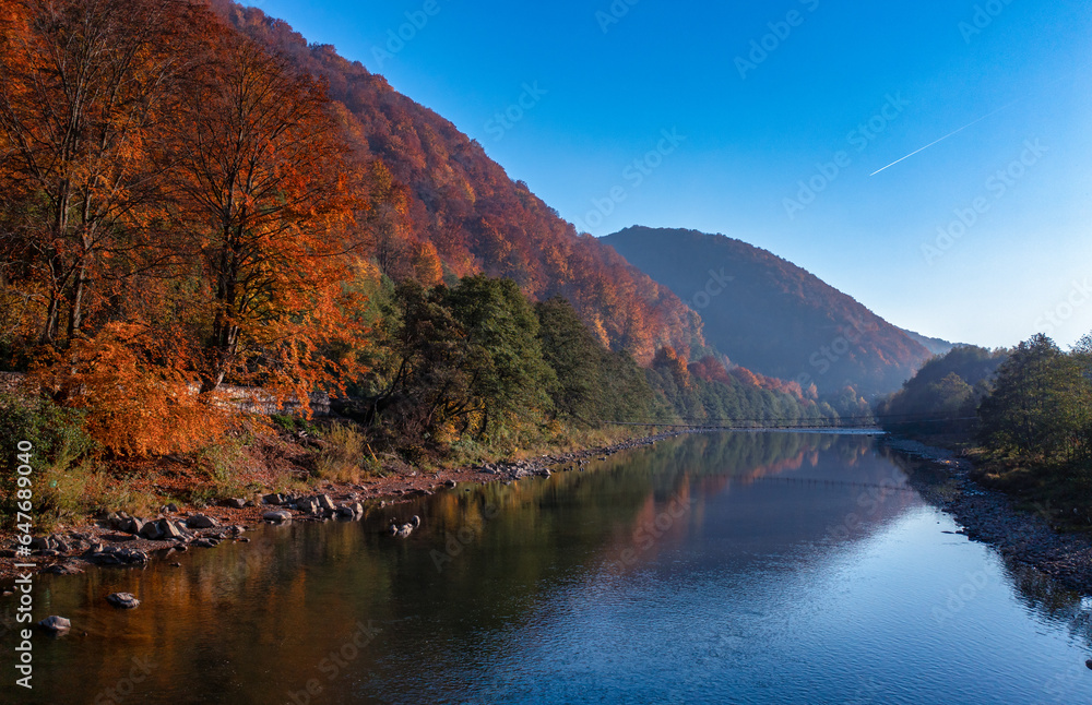 Autumn's Embrace: Mountain Lake Amidst Fall-Foliage Hills