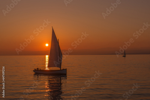 Sailboat sailing on a lake at the sunset in lake Leman, Switzerland