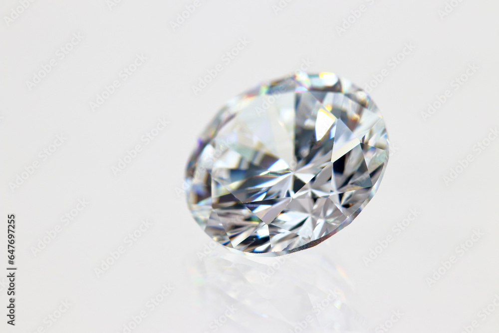 Closeup round cut cubic zirconia (CZ) diamond simulant on white background (photo) Closeup round cut cubic zirconia (CZ) diamond simulant on white background (photo)