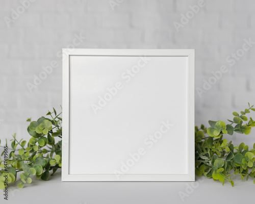 Minimal wooden picture poster frame mockup on white wallpaper © Katarzyna
