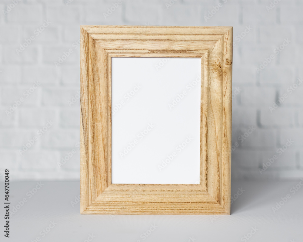 Minimal wooden picture poster frame mockup on white wallpaper Minimal wooden picture poster frame mockup on white wallpaper