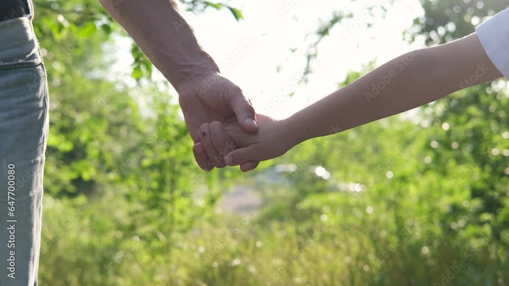 The father takes his son by the hand. Hands of dad and child. The father takes his son by the hand. Hands of dad and child.
