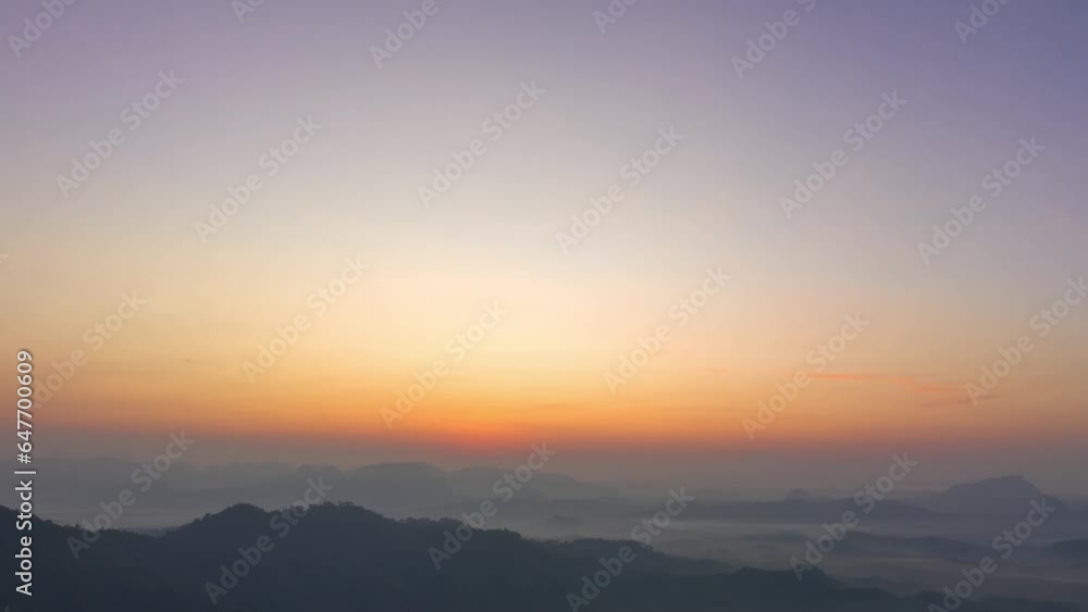aerial hyperlapse view amazing colorful in the pink sky at dawn over the misty sea in the valley. .colorful sky at twilight above the mountain range. .Mist covers the complicated mountain ranges. aerial hyperlapse view amazing colorful in the pink sky at dawn over the misty sea in the valley. .colorful sky at twilight above the mountain range. .Mist covers the complicated mountain ranges.