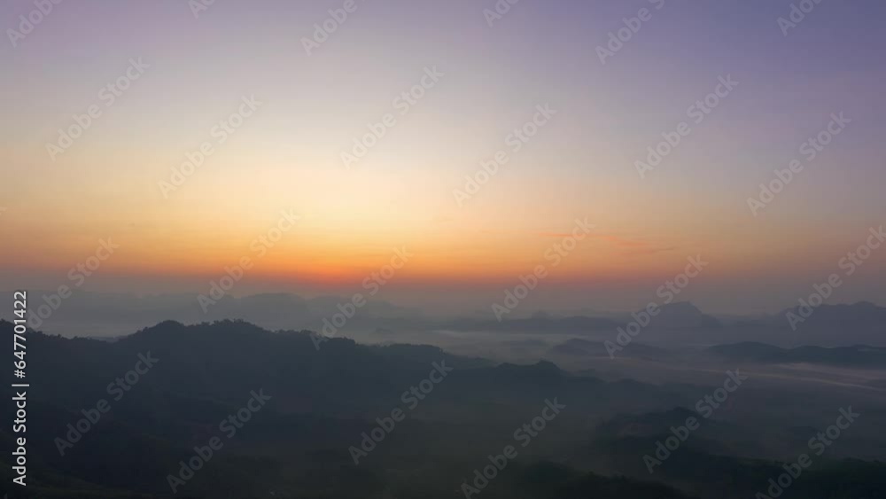 aerial hyperlapse view amazing colorful in the pink sky at dawn over the misty sea in the valley. .colorful sky at twilight above the mountain range. .Mist covers the complicated mountain ranges. aerial hyperlapse view amazing colorful in the pink sky at dawn over the misty sea in the valley. .colorful sky at twilight above the mountain range. .Mist covers the complicated mountain ranges.