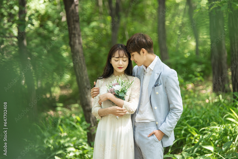 A loving couple is taking wedding photos outdoors for their wedding. A loving couple is taking wedding photos outdoors for their wedding.