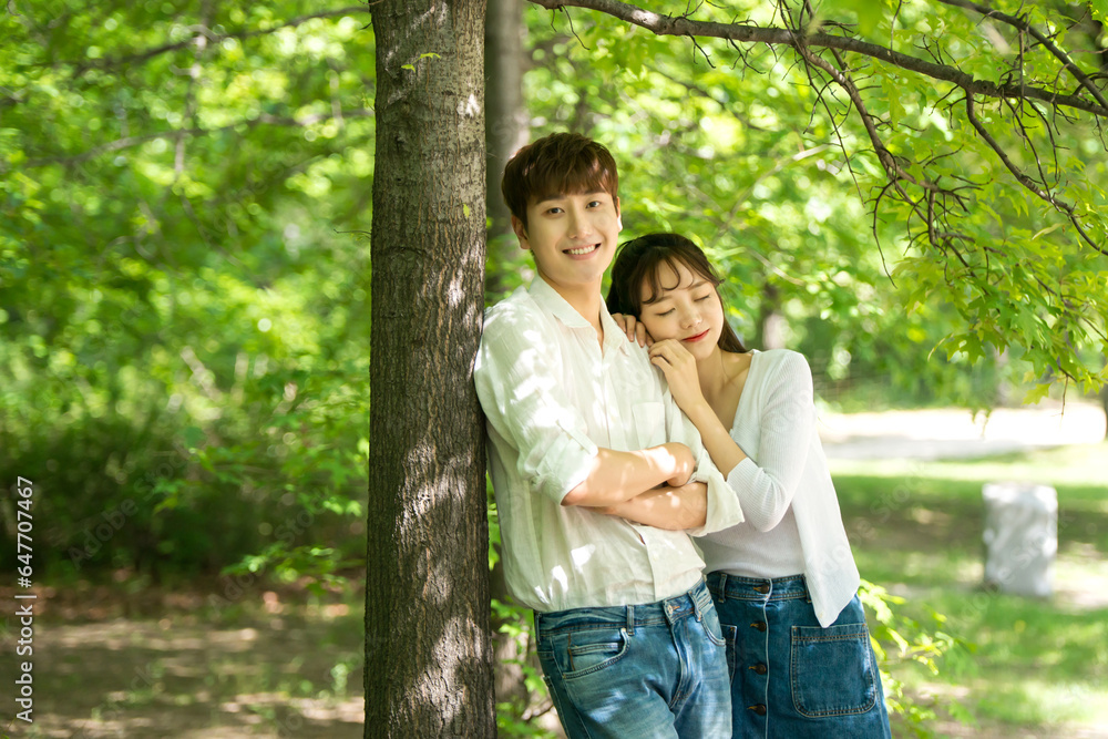 A lovely young couple are having fun in a forested park. A lovely young couple are having fun in a forested park.