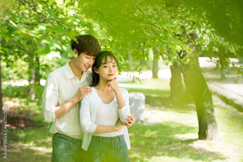 A lovely young couple are having fun in a forested park. A lovely young couple are having fun in a forested park.