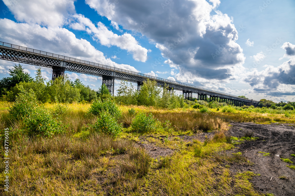 A panorama view along the side of the Bennerley Viaduct over the Erewash canal in summertime