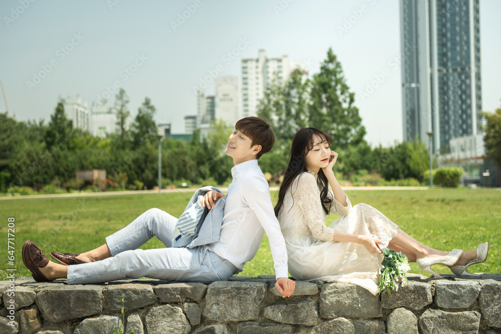 A loving couple is taking wedding photos outdoors for their wedding.