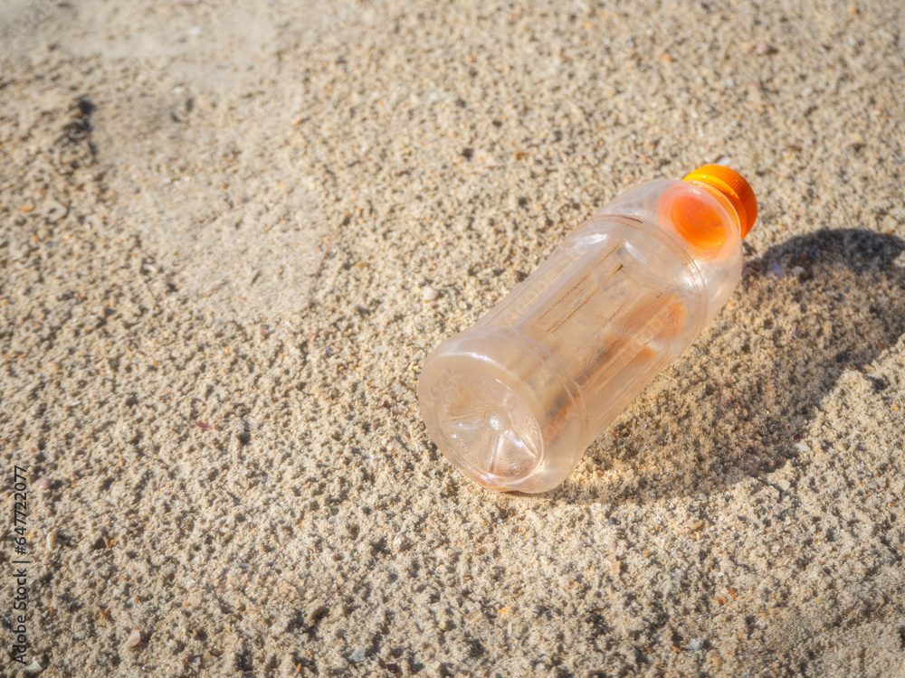 Plastic bottles on the sandy beach Plastic bottles on the sandy beach