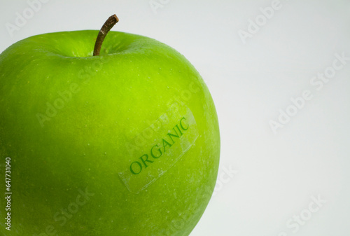 A Granny Smith Apple With An Organic Label; Waterloo, Quebec, Canada photo