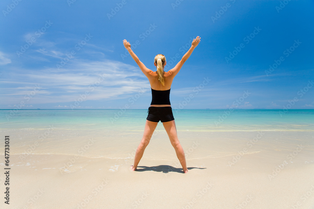 A Woman Does Yoga On A Tropical Island; Koh Lanta, Krabi Province, Thailand