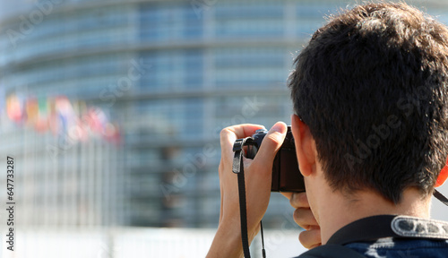 Young photogapher with digital camer  during a travel photo