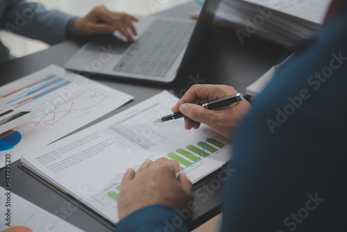 Financial Business team present. Business man hands hold documents with financial statistic stock photo, discussion, and analysis report data the charts and graphs. Finance Financial concept