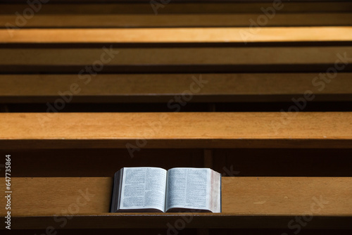 A bible open on a wooden bench; Northumberland england photo