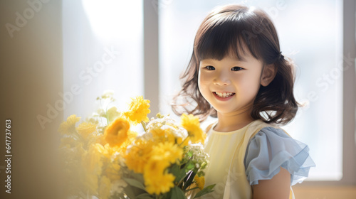 Little girl holds a bouquet of flowers in her hands