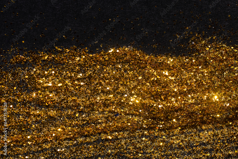Abstract shiny glittering waves.hand-drawn brush with golden strokes on black background.