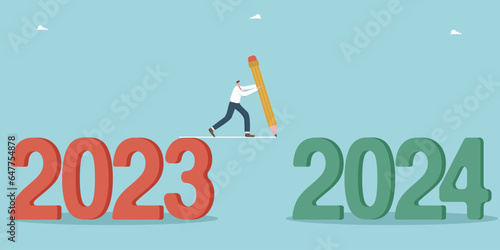 Positive attitude and motivation for success and business growth in new year 2024, overcoming obstacles and solving unfinished tasks and transition to the new year, man draws a line from 2023 to 2024.