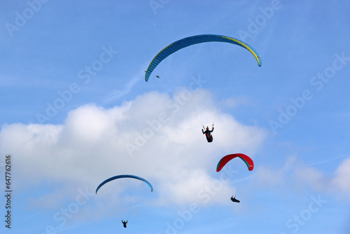  Paragliders flying in a blue sky