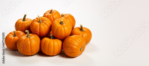 a pile of pumpikins on white background  banner with copy space