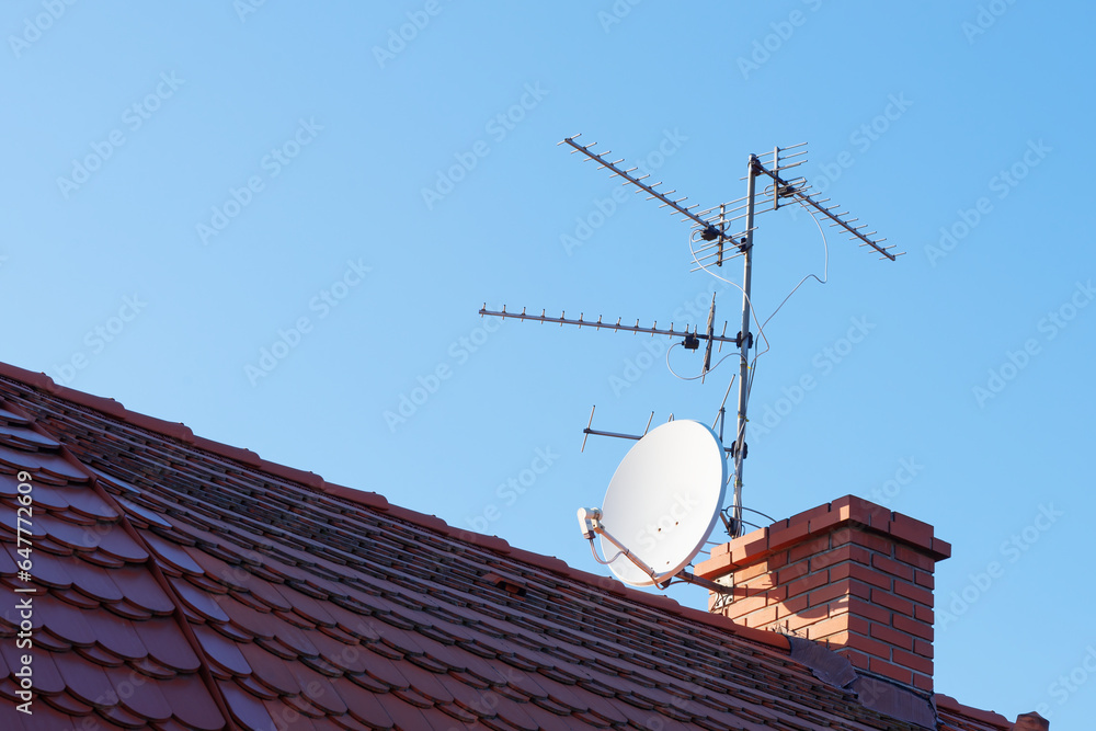Passive analogue and satllite TV antennas on roof fixed to chimney Passive analogue and satllite TV antennas on roof fixed to chimney