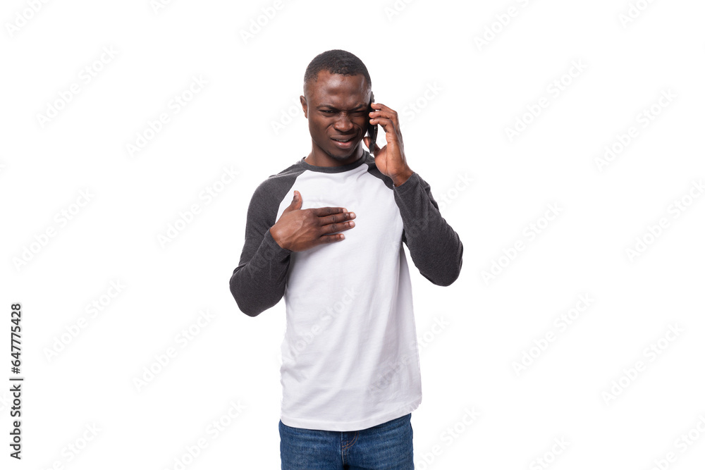 a young American man with a short haircut wearing a casual jacket speaks on the phone a young American man with a short haircut wearing a casual jacket speaks on the phone