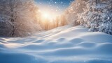 Winter snow landscape with snowdrifts under beautiful light and snow flakes on blue sky in the evening, banner format, copy space