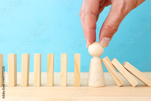 stopping the domino effect. executive and risk control concept