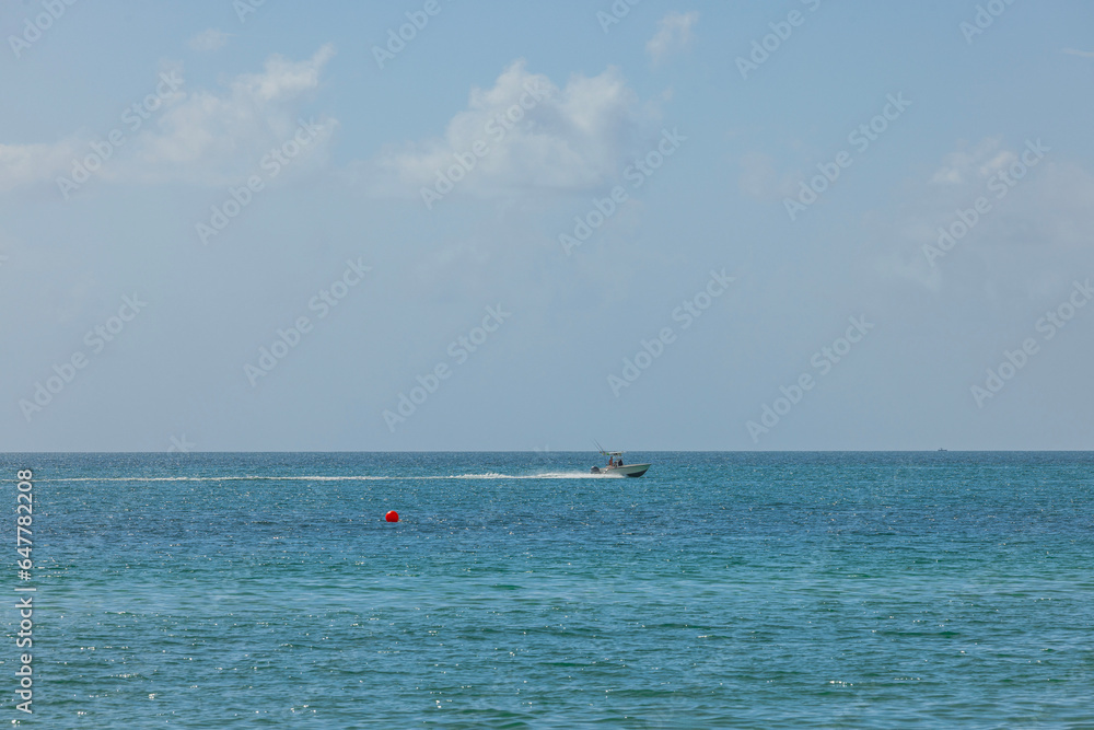 Beautiful view of motor boat moving across blue waters of Atlantic Ocean. Miami Beach. 