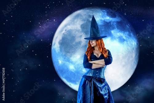 Witch on Halloween. Female wizard fairy character for All Saints\' Day. Fantasy gothic red-haired Vampire girl in black dress. Enchantress dressed in carnival costume