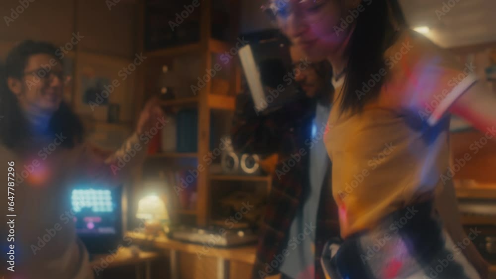 Young man holding boombox and his friends enjoying dancing at party in garage, 90s aesthetics Young man holding boombox and his friends enjoying dancing at party in garage, 90s aesthetics