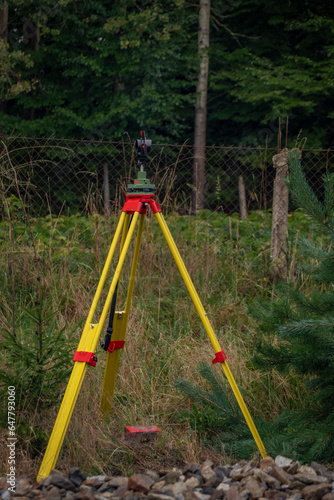 Surveyors with instruments on railway track near green forest in south Bohemia