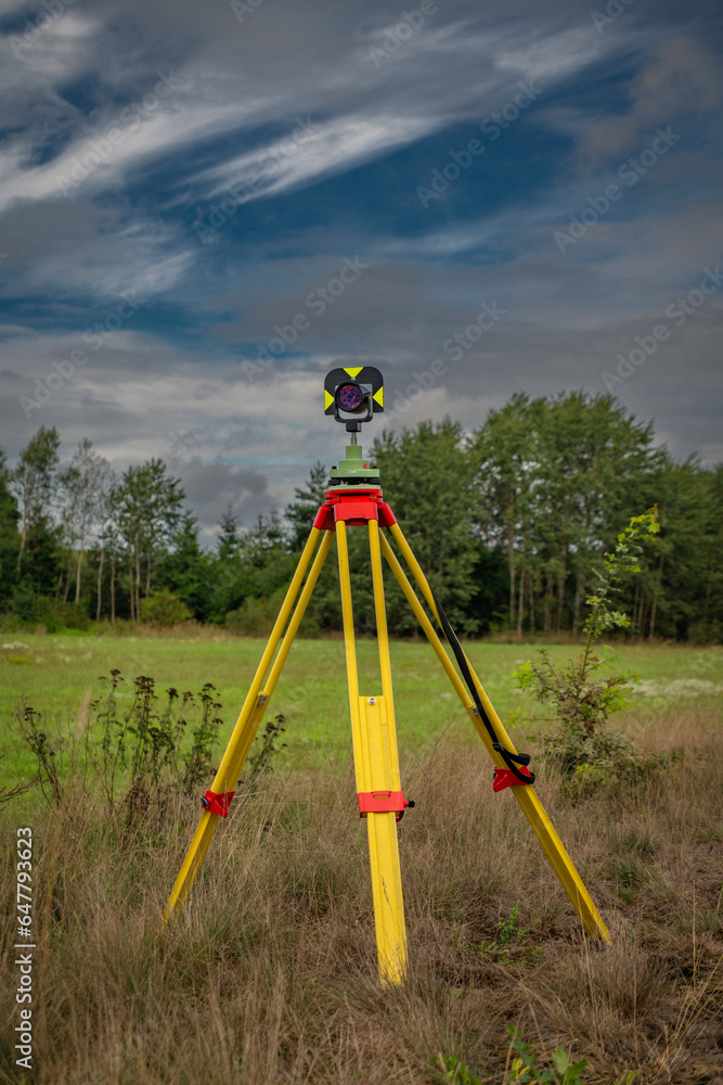 Fototapeta premium Surveyors with instruments on railway track near green forest in south Bohemia