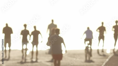 Wallpaper Mural Blurred silhouettes of people walking on the embankment in bright white light Torontodigital.ca