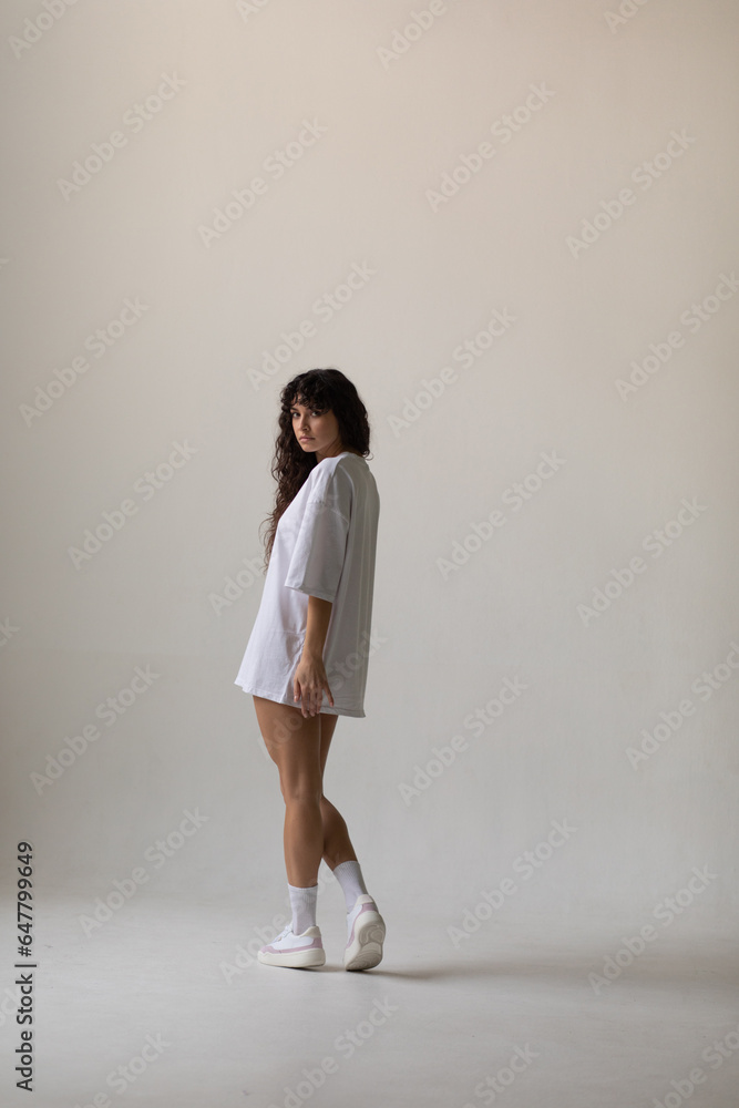 Attractive woman with curly hair in oversized t-shirt. Mock-up. Attractive woman with curly hair in oversized t-shirt. Mock-up.