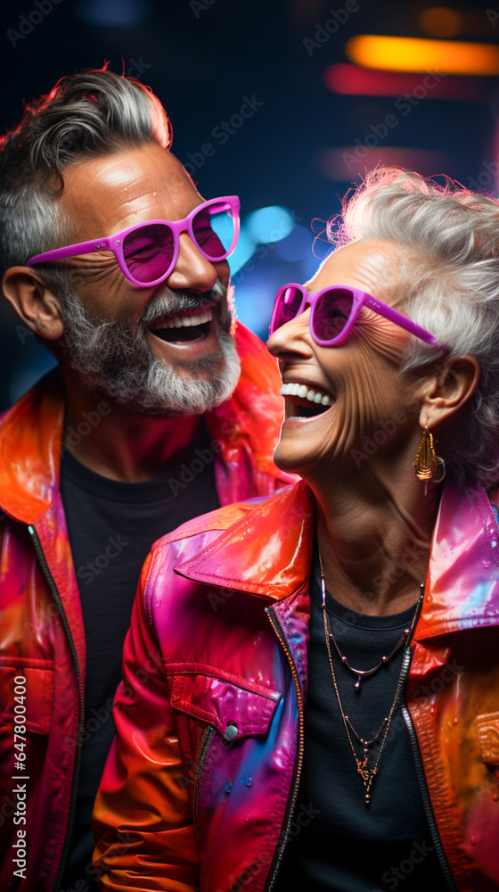 Modern Old Lady Women & Man Smiling with Sun Glasses on Pink & Blue Background. Neon Dark Stage Shows Empty Room: Neon Light, Spotlights, Dance Floor. Modern Old Lady Women & Man Smiling with Sun Glasses on Pink & Blue Background. Neon Dark Stage Shows Empty Room: Neon Light, Spotlights, Dance Floor.