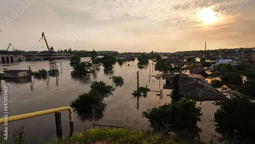 Flooded streets in Kherson town with beautiful sunset at background. Explosion of dam on Dnipro river in city of Novaya Kakhovka. Consequences of detonation of Kakhovka Hydroelectric Power Station photo