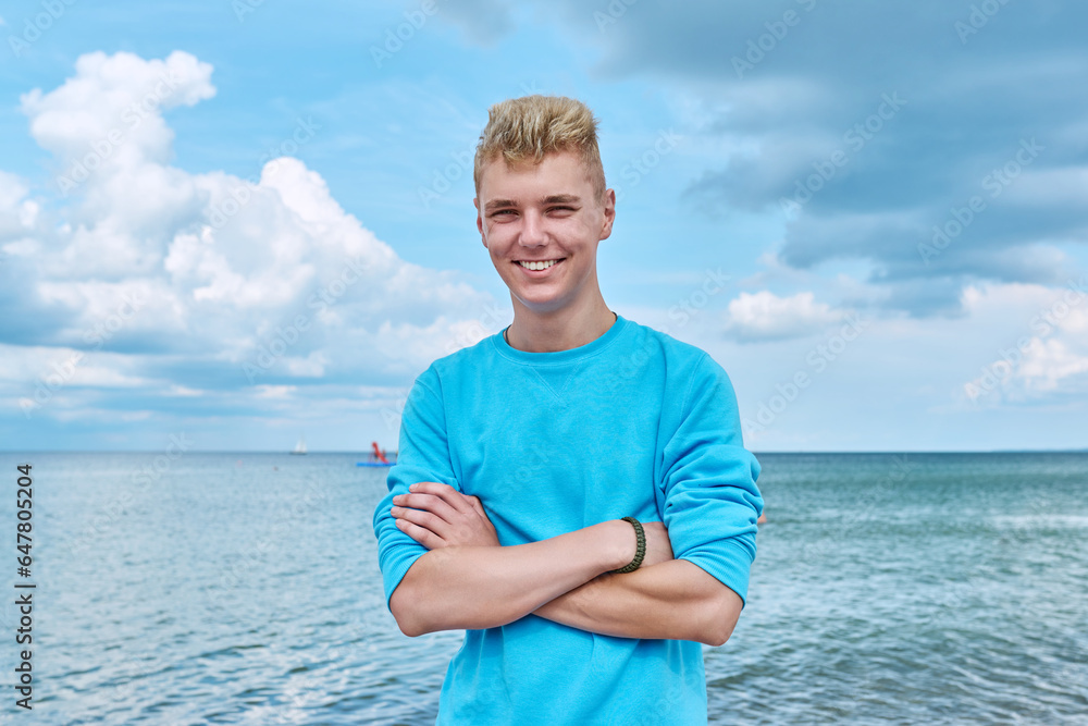 Portrait of smiling young guy outdoor, on sea beach Portrait of smiling young guy outdoor, on sea beach
