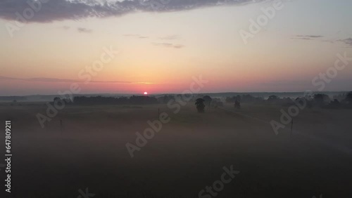 The early morning with sunrise among the fields and fog. You may see horizon and landscape from the higher point of view.