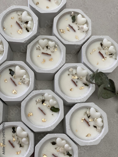 White concrete votive candles decorated with small heart fondants and dried flowers. Saint Valentine Or Wedding candles.