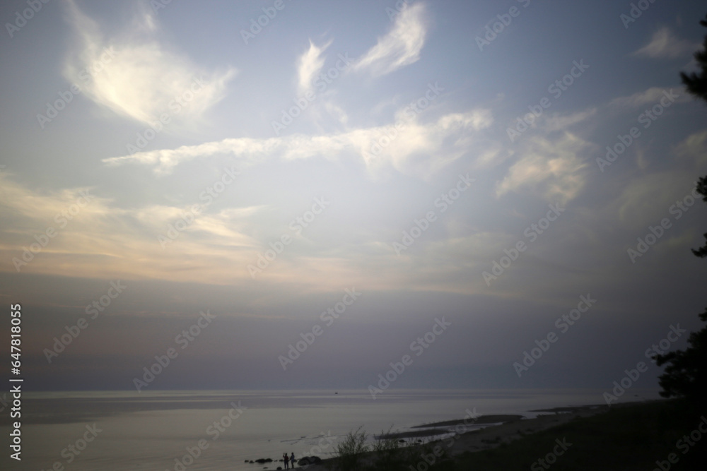 Obraz premium Amazing calm scenery of a blue sky and tranquil sea with light fog above, selective focus