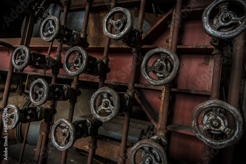 Steering wheels and valves in an abandonend industry complex photo