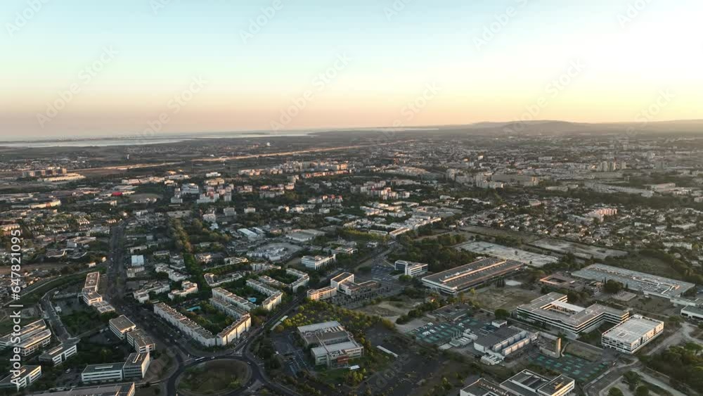 Sunset casts a warm glow over Montpellier's modern quarter, where the train station and highways converge.

