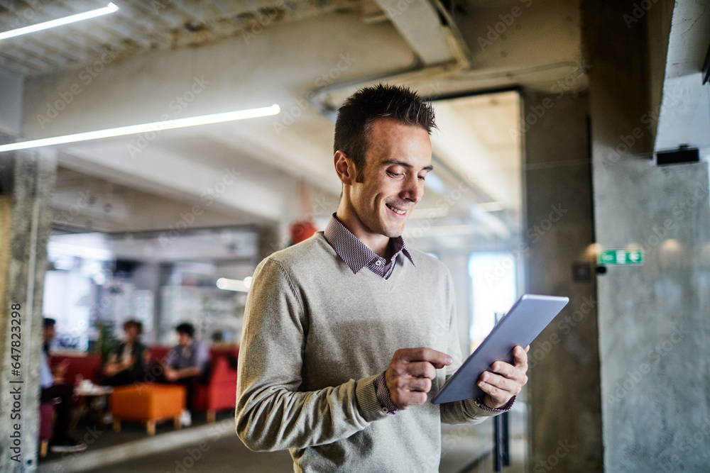 Young caucasian man using a tablet in a modern business office Young caucasian man using a tablet in a modern business office
