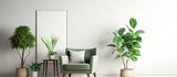Green armchair with plants black poster and empty space on white wall