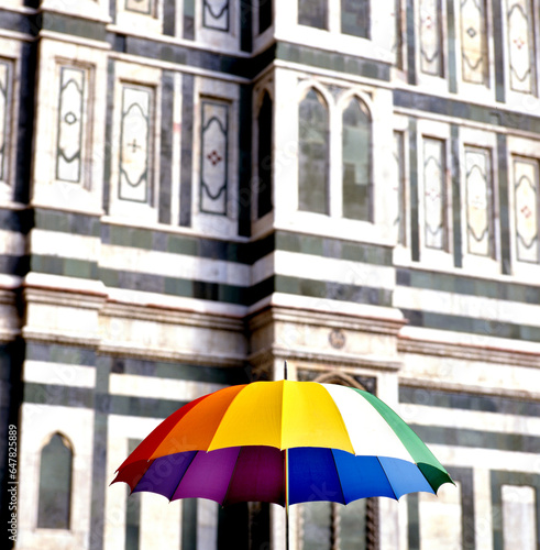Multi colored umbrella in front of the cathedral of Siena