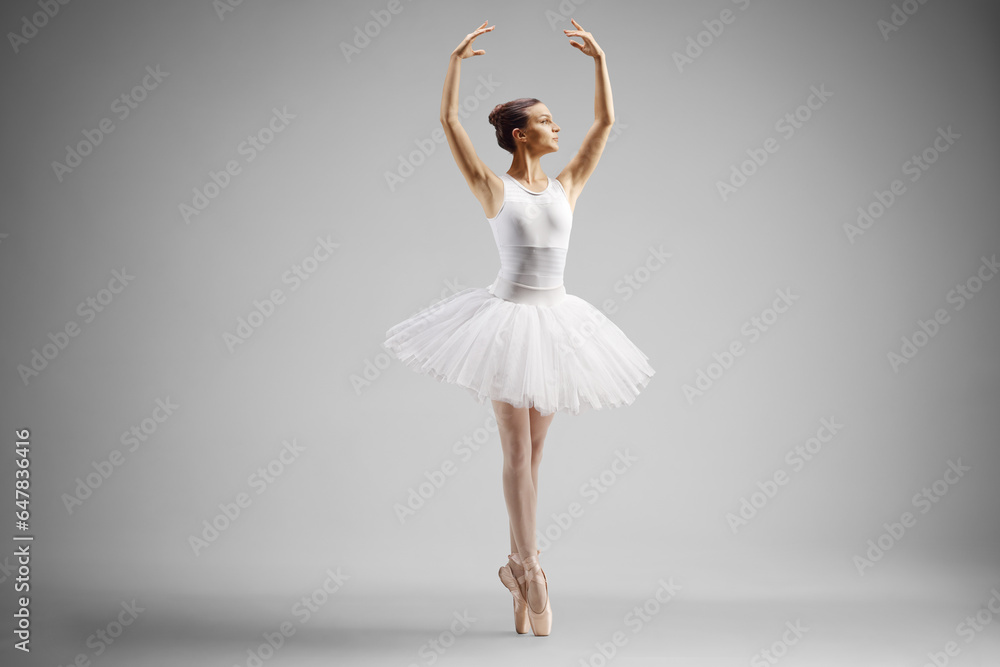Ballerina in a white dress dancing with arms up Ballerina in a white dress dancing with arms up