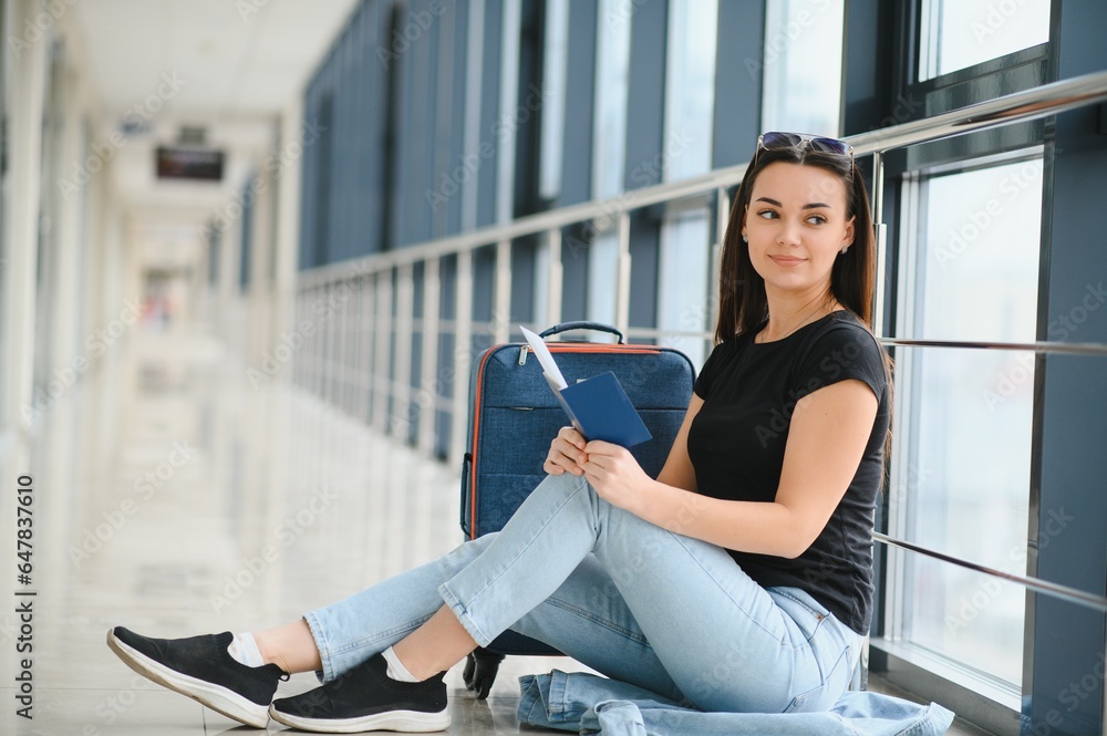 Fototapeta premium happy woman waiting for flight at airport
