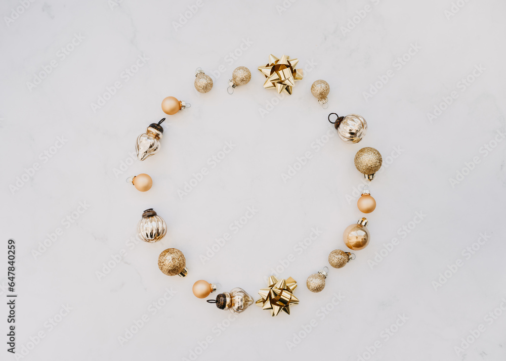 Flat lay of round frame of golden Christmas decorate on white background Flat lay of round frame of golden Christmas decorate on white background